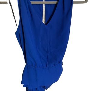 XOXO Blue top with open back . Size S .